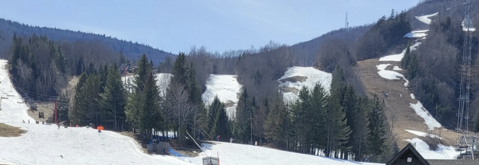 melty slopes with exposed grass patches - a bluebird day at hunter mountain in spring